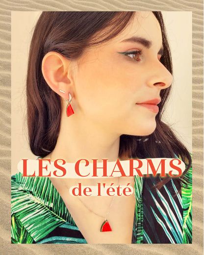 Portrait d'une femme portant des bijoux aux oreilles et au cou en forme de pastèque. Du texte titre l'image : "Les charms de l'été".